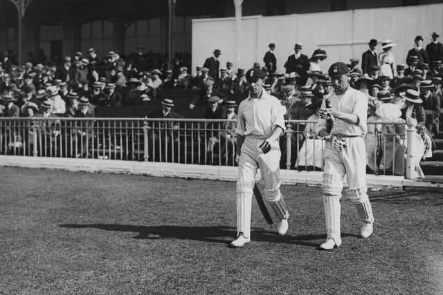 Legendary England cricketer Jack Hobbs and Phil Mead go out to bat during a Test Trial match in June 1911.