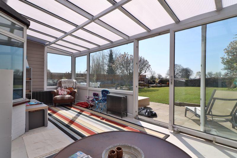 Large glass-panelled conservatory.