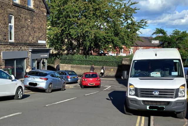 Vehicles parked on double yellow lines at a busy junction at school run time by Hunters Bar school.