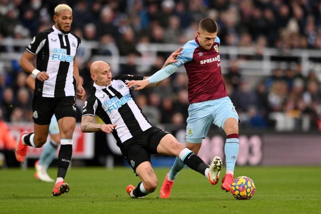 Johann Gudmundsson of Burnley is tackled by Jonjo Shelvey of Newcastle United during the Premier League match between Newcastle United and Burnley at St. James Park on December 04, 2021 in Newcastle upon Tyne, England. (Photo by Stu Forster/Getty Images)