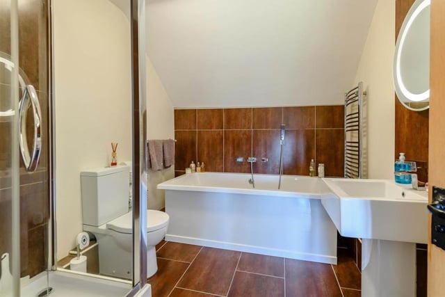 The second floor also houses a second family bathroom, complete with a modern four-piece suite. It comprises a large bath-tub, separate shower enclosure, pedestal wash hand basin with fitted mirror and LED lighting above, and a low-flush WC, not to mention a heated towel-rail.