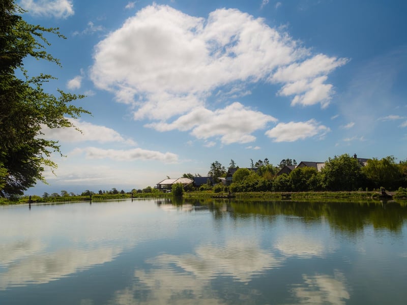 The boathouse's two balconies enjoy views over a calming fishing pond.