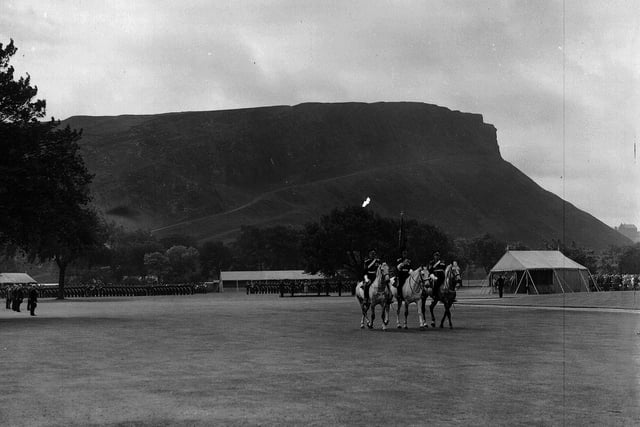 The Scots Greys' Guidon ceremony at the Palace of Holyroodhouse is pictured, with Salisbury Crags in the background. It was part of a series of events held to mark Queen Elizabeth II and the Duke of Edinburgh's visit to Edinburgh on their tour of Scotland in 1956.