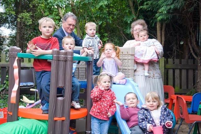 St Leger Homes of Doncaster gave the Evanston Gardens Toddler Group  money to buy fencing, to make their toddlers’ play area safe and secure, and for additional toys. 
Pictured in 2009 was John Young, Chairman of St Leger Homes, and Sue Wostenholm, of the toddler group, with some of the youngsters trying out the new play castle.