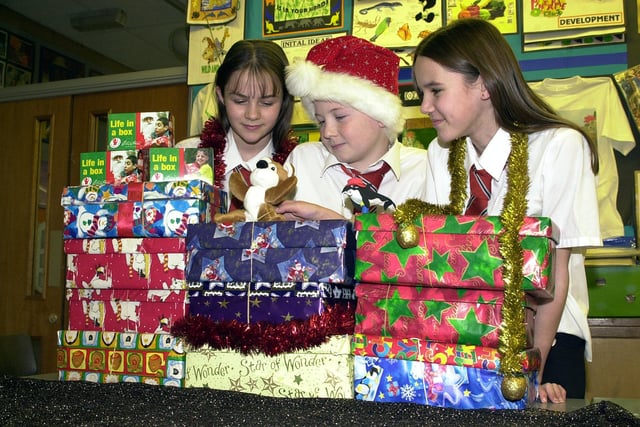 Hungerhill School helped two charities in 2002 the Samaritan's Purse "Operation Christmas Child" Shoebox Appeal and the Children In Distress "Life in a Box"-small change equals big difference appeal. Our picture shows pupils, from left, Vicky Johnson, aged 12, Jonathan Preston and Charlotte Fowkes, both aged 11, with some of the boxes and donations.