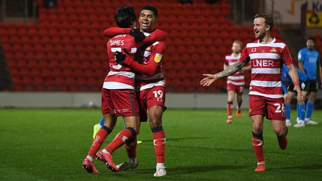 Tyreece John-Jules and James Coppinger celebrate with Reece James after he gave Rovers the lead. Picture: Andrew Roe.
