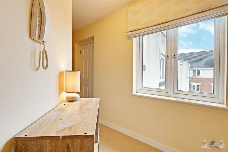 The apartment includes a welcoming entrance hall with a large internal storage cupboard.