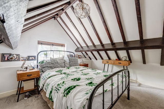 A good sized master bedroom which has a high ceiling with original oak beams and two useful storage cupboards.