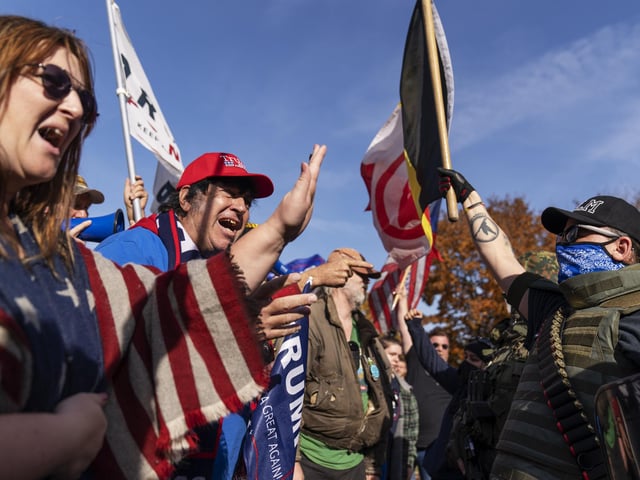 Trump supporters, left, demonstrating the election results are confronted by counter protestors at the State Capitol in Lansing, Mich.(AP Photo/David Goldman)