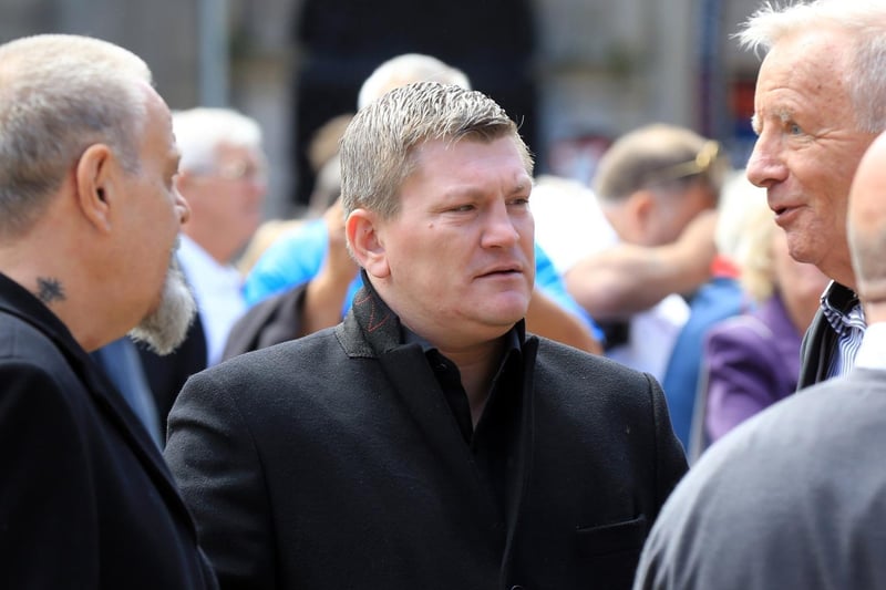 Boxer Ricky Hatton speaking to other mourners at the funeral