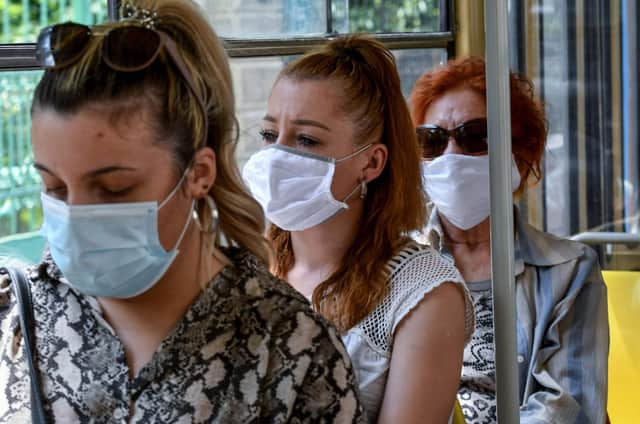 Passengers travel wearing facemasks on a tram (Photo by DENIS LOVROVIC / AFP) (Photo by DENIS LOVROVIC/AFP via Getty Images)