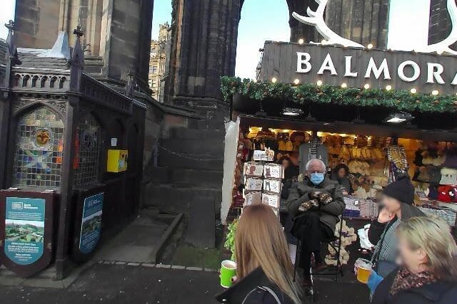 With Bernie attending the Christmas markets in this spot, which famous monument is he sitting under?