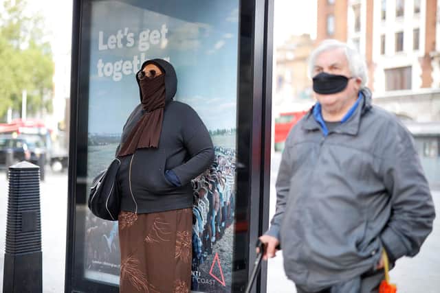 People have been told to wear a face mask if possible when using public transport or shopping (Photo by TOLGA AKMEN/AFP via Getty Images)