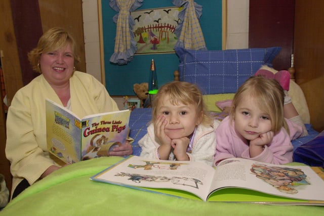 Marie Shaw from Shortbrook Primary School, Westfield, Sheffield getting in some bedtime reading with pupils Courtnay Lee and Adrianne Boulton on World Book Day in March 2002