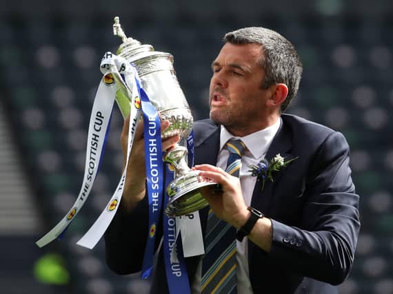 St Johnstone manager Callum Davidson celebrates with the Scottish Cup trophy after the final whistle during the Scottish Cup final match at Hampden Park, Glasgow.