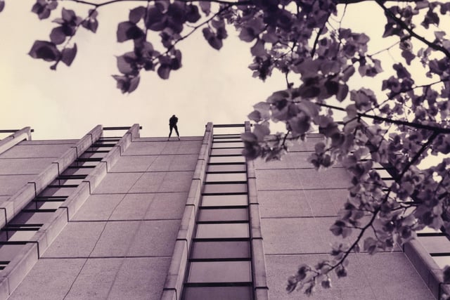 An abseiler descends Fareham Civic Offices during a mass abseil for charity in 1993. The News PP4404