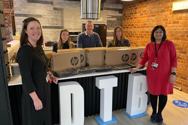 Tapton School headteacher Kat Rhodes, left, and deputy-headteacher Harkiran Grewal, right, with Chris Booker and the team at Deeper Than Blue, which has donated 15 laptops to the school.