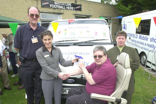 Pictured in the Civic Square, Dronfield, where  a new Shopmobility scheme was launched for local people with mobility problems in 2001. Seen LtoR  are, Clive Roe Shopmobility organiser, Janette McHardy manager of Abbey National Chesterfield  who sponsored the mini bus, as she hands the keys over to Ian White Chairman of Shopmobility, and Heather Roe shopmobility organiser.