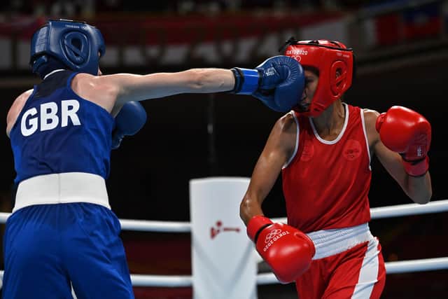 Moroco's Rabab Cheddar (red) and Britain's Charley-Sian Davison fight during their women's fly (48-51kg) preliminaries boxing match during the Tokyo 2020 Olympic Games.