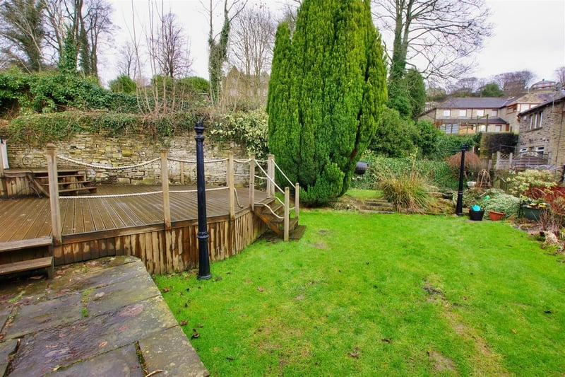 The garden features a lawn and decking.
