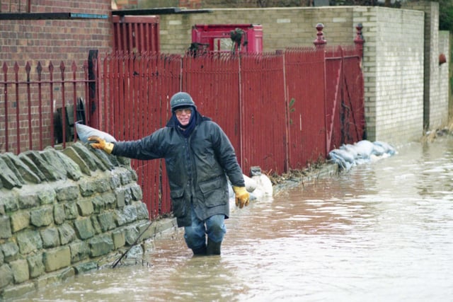 Stephen Smith helps protect the Moorings Boat Club in Ferryboat Lane, from the floods in 1996. Does this bring back memories?
