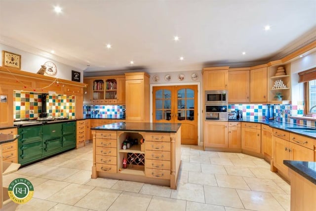 The spacious and bespoke fitted kitchen with central island.