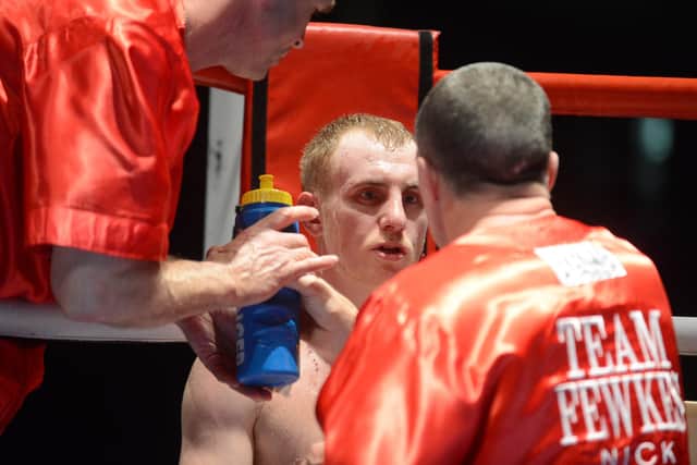 John gets corner advice from his trainer Glyn Rhodes during his win over William Warburton at Ice Sheffield in 2013.
