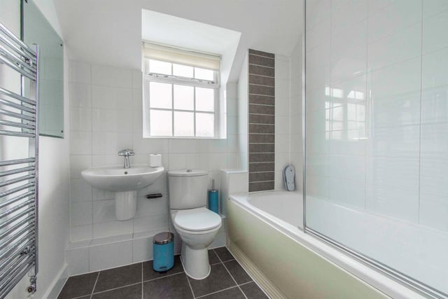 Family Bathroom  - Fitted with a WC, a wash hand basin with mixer tap and a bath with shower attachment and screen. There is a heated towel rail, spotlights to the ceiling, partial tiling to the walls and tiled flooring. With a rear facing opaque double glazed window.