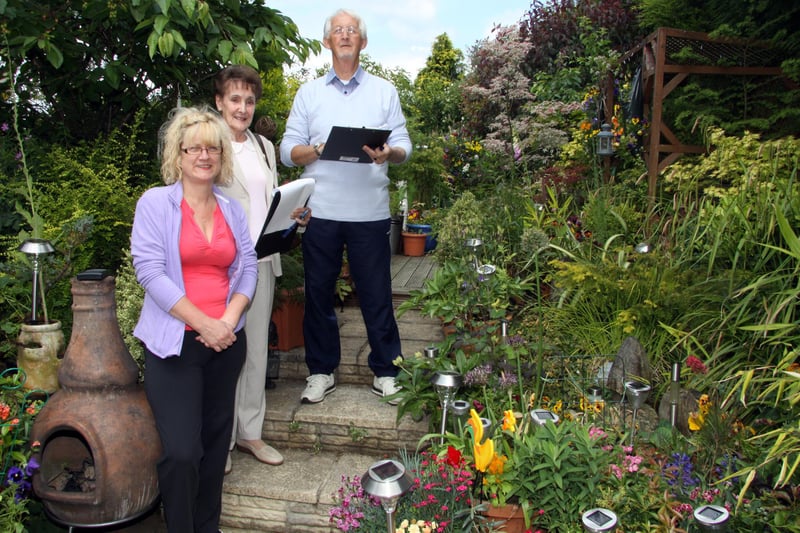 Margaret White in her Brimington garden with Chesterfield In Bloom judges Barbara Matchett and Stephen Land in 2013.