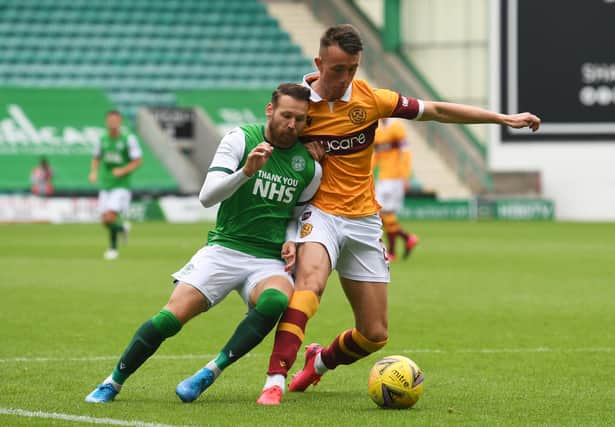 Martin Boyle and David Turnbull battle for the ball