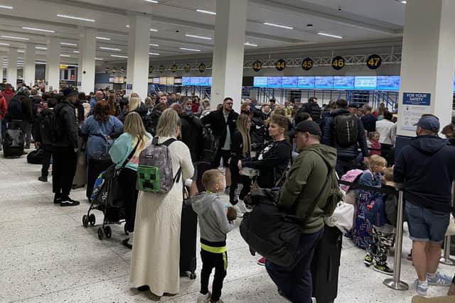 Passengers queue inside the departures area of Terminal 1 at Manchester Airport. PA Photo. Photo credit should read: Peter Byrne/PA Wire