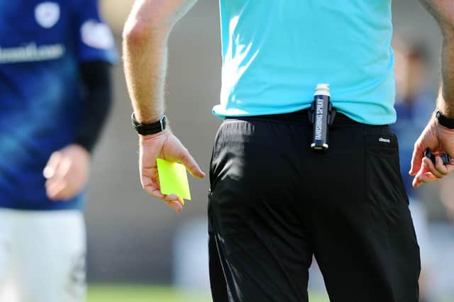 Which Ladbrokes League 1 referee has shown the most cards this season?
