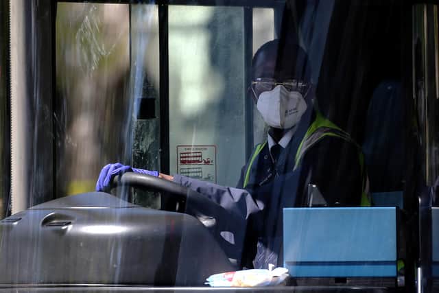 A bus driver wears a facemask (Photo by ISABEL INFANTES/AFP via Getty Images)