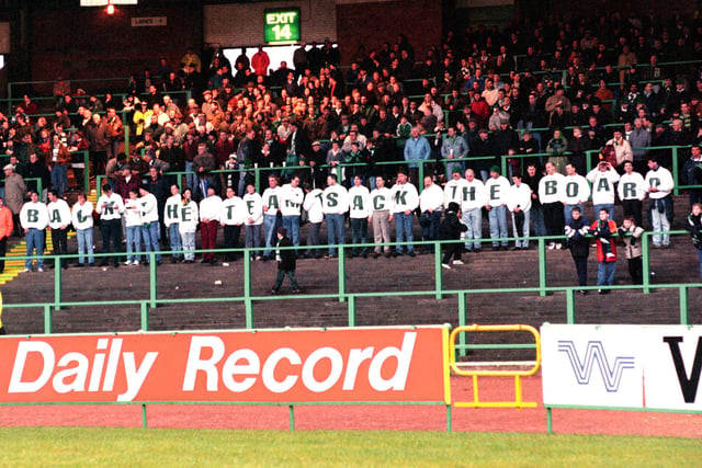 Celtic fans wear t-shirts spelling out the slogan 'Back the team - sack the board' during a home game against Hibs in December 1993