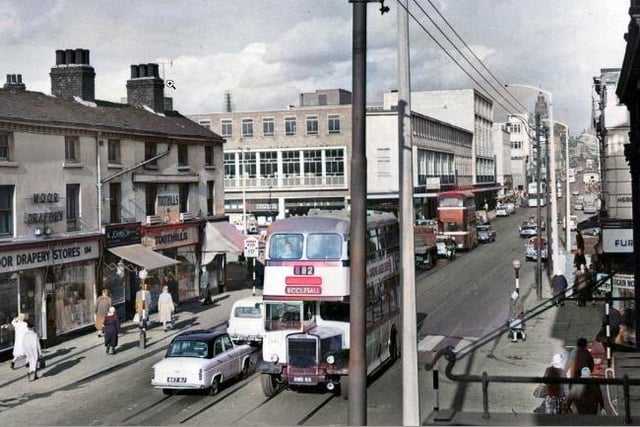 The AI colouristion can been seen on the buses on this picture of The Moor in 1960, but Sheffield buses were not known for their red detail.