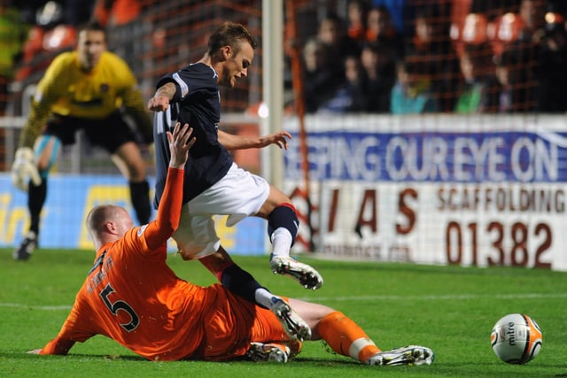 Kallum Higginbotham and Gary Kenneth tangle fter Johnny Russell's equaliser
