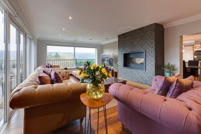 This lounge space has stunning views of the surrounding country and is just through from the dining kitchen.