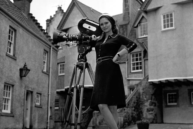 British actress - and national treasure - Joanna Lumley with a film camera in White Horse Close, Edinburgh, while making a film for Scottish Cashmere in October 1972.