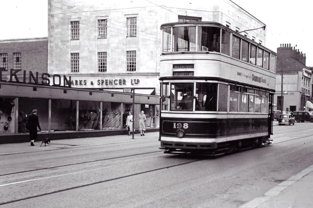 A tram makes its way down The Moor