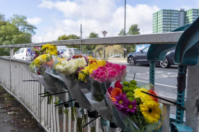 Flowers at the scene of a RTC on Moore Street. 23 year old Junaid Latif died in hospital on Sunday. Picture Scott Merrylees