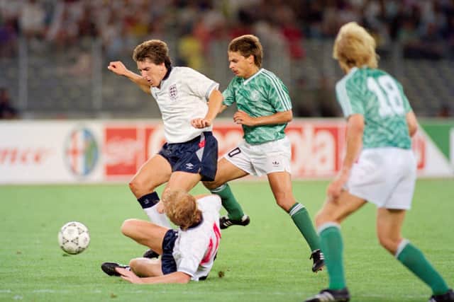 TURIN, ITALY - JULY 04:  England players Mark Wright (floor) and Peter Beardsley combine to thwart Olaf Thon of West Germany during the 1990 FIFA World Cup Semi Final at Stadio delle Alpi on July 4th, 1990 in Turin, Italy.  (Photo by Simon Bruty/Allsport/Getty Images)