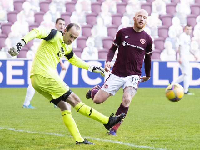 Rovers goalkeeper Jamie MacDonald clears.