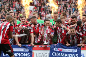 Leon Clarke eventually opened the champagne before spraying it all over his teammates - Pic David Klein/Sportimage