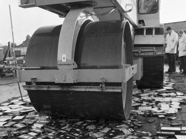 500 pirate video tapes, seized by Trading Standards officers, are crushed by a road roller in Edinburgh, January 1990,  on behalf of Lothian Regional Council.