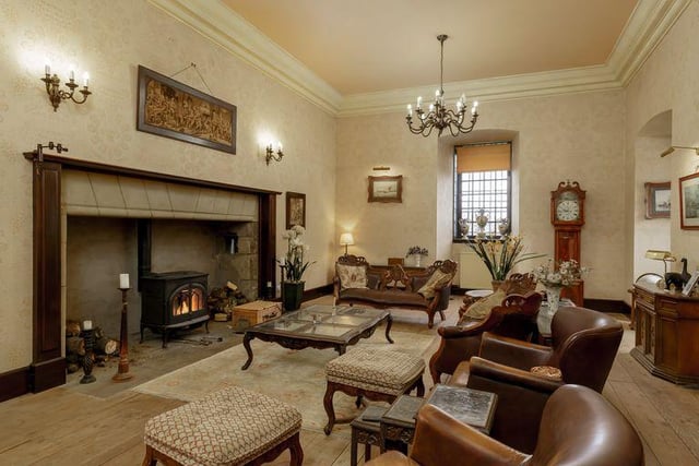 The drawing room has an original fireplace and triple aspect views.
