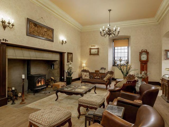 The drawing room has an original fireplace and triple aspect views.