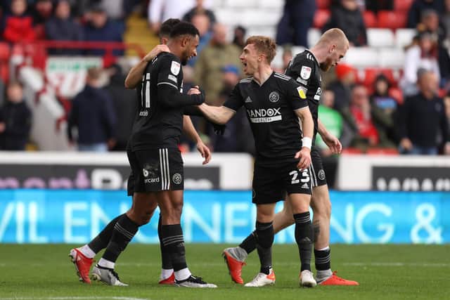 Lys Mousset of Sheffield United celebrates with team mate Ben Osborn after scoring his second goal during the Sky Bet Championship match between Barnsley and Sheffield United at Oakwell Stadium on October 24, 2021 in Barnsley, England. (Photo by George Wood/Getty Images)