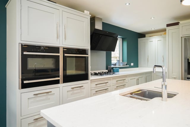 The open-plan kitchen is finished with quartz worktops and integrated appliances