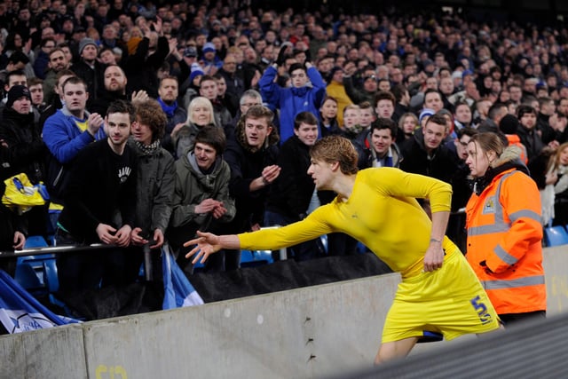 Wednesday skipper Glenn Loovens throws his shirt into the away end after his side's 2-1 defeat at Manchester City in the third round of 2015.
