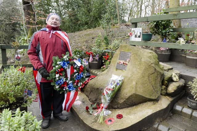 Tony Foulds tending to the memorial to the crew of the Mi Amigo that crashed in Endcliffe Park on the seventy-sixth anniversary of the disaster.